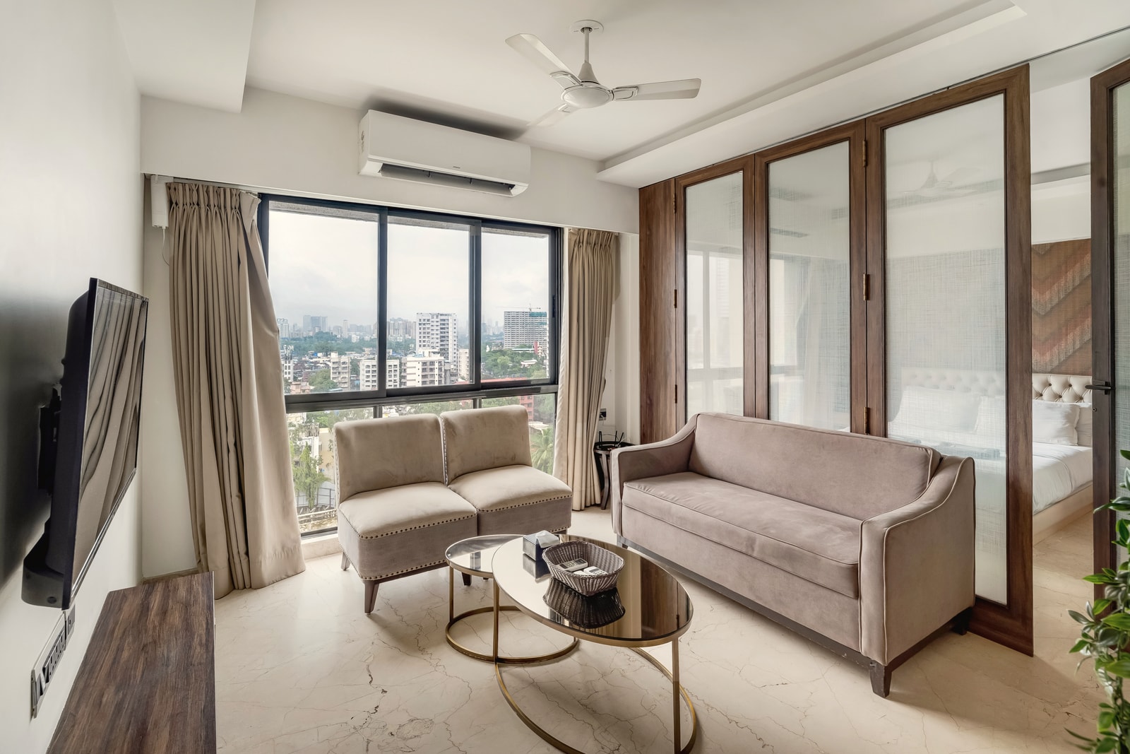 The living room at Amalfi, BKC, with the city beyond the window